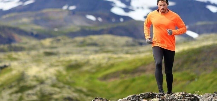 Man on a remove running trail in the mountains.