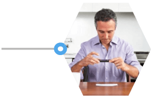 Man taking a picture from his phone to upload his biometric results into the portal.