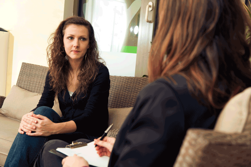 Two individuals in deep discussion as part of the counseling offered with the wellness program.