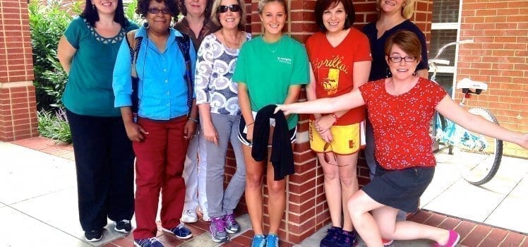 Group of coworkers posing for a picture as a wellness committee.