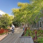 Courtyard with biking path and seating within a modern office building.