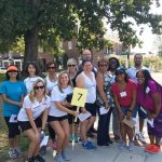 Group of workers on an outdoor scavenger hunt during a team building exercise.