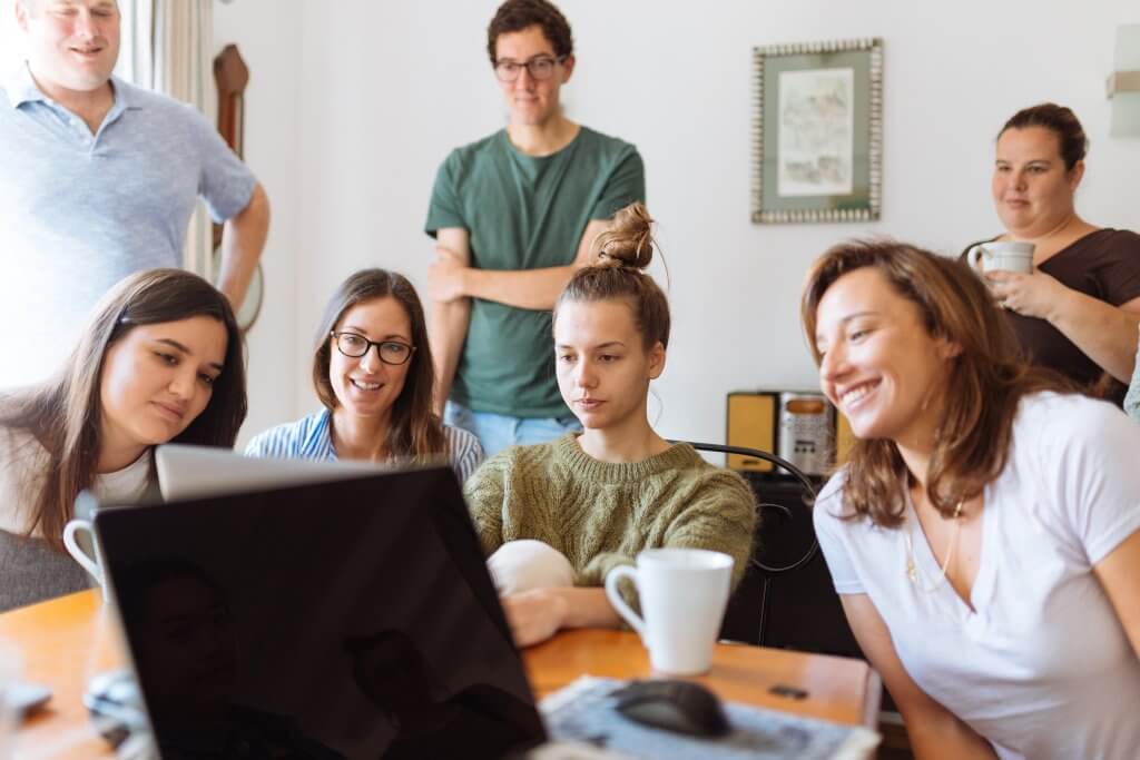 Employees reviewing the health observances calendar on a computer.