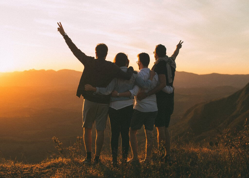 Motivated employees reaching top of trail