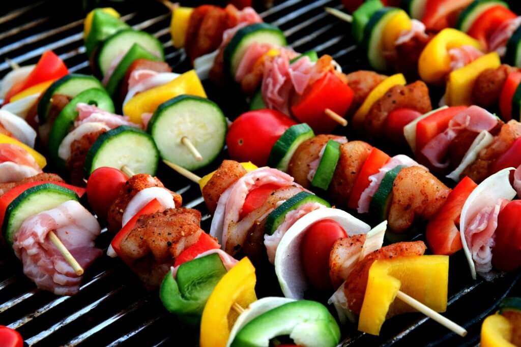 Close up of vegetable ka bobs on a grill.