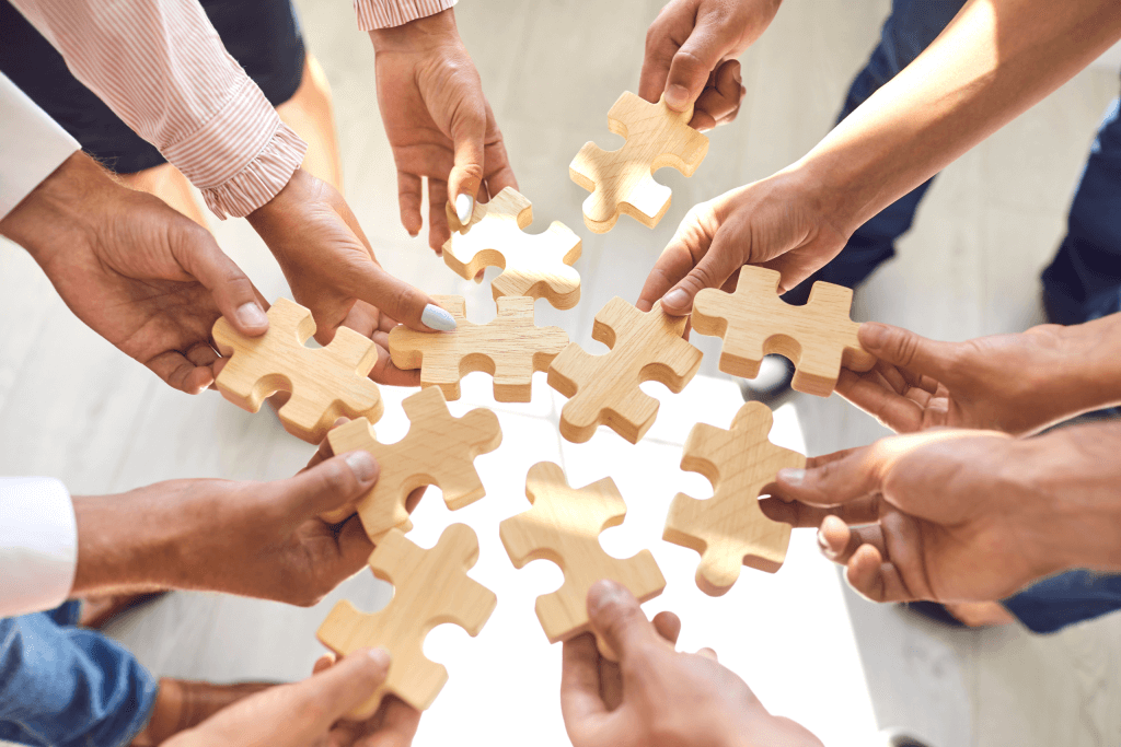 a group of people each with a puzzle piece