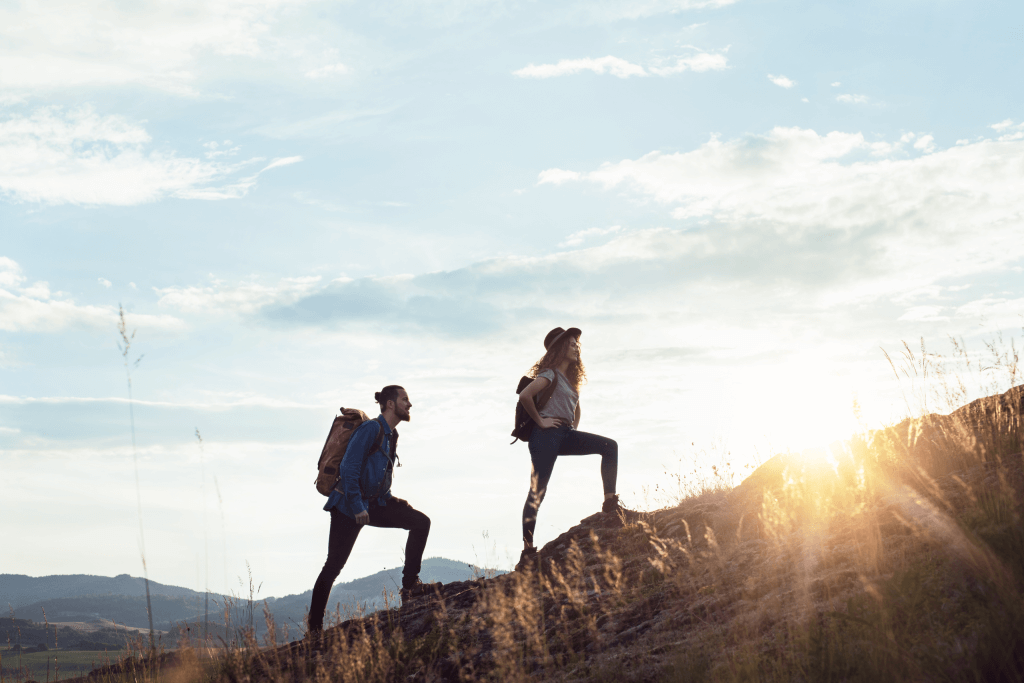 2 people climbing a mountain