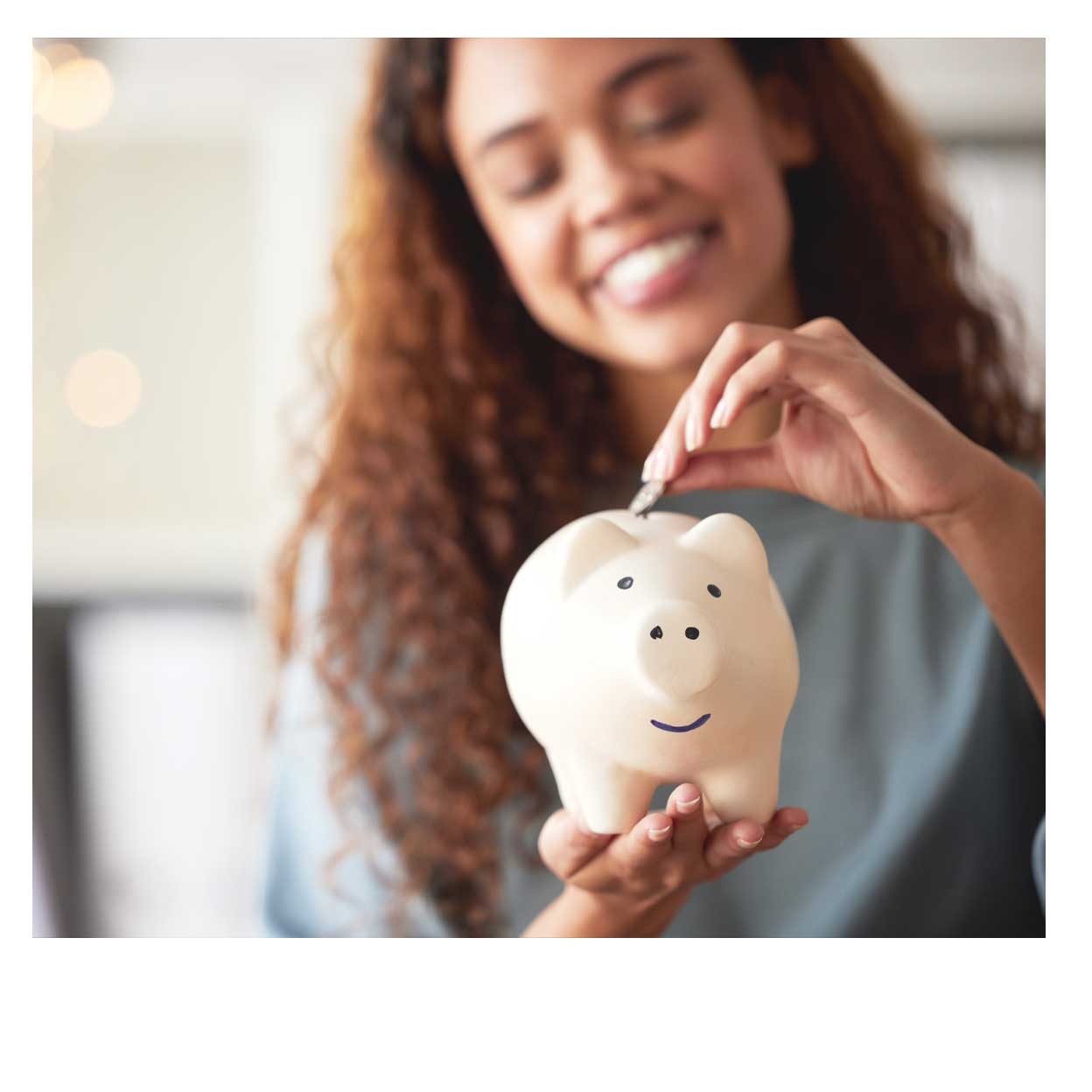 woman putting money into a piggy bank