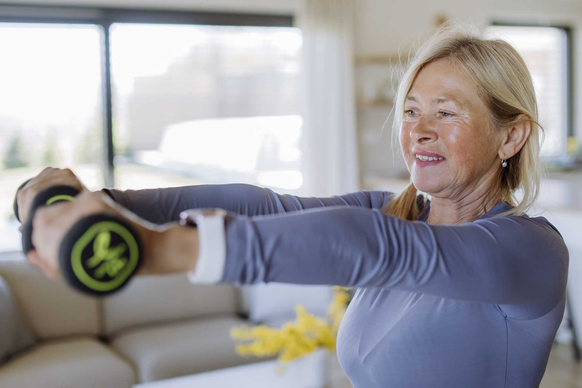 mature woman lifting dumbbells 