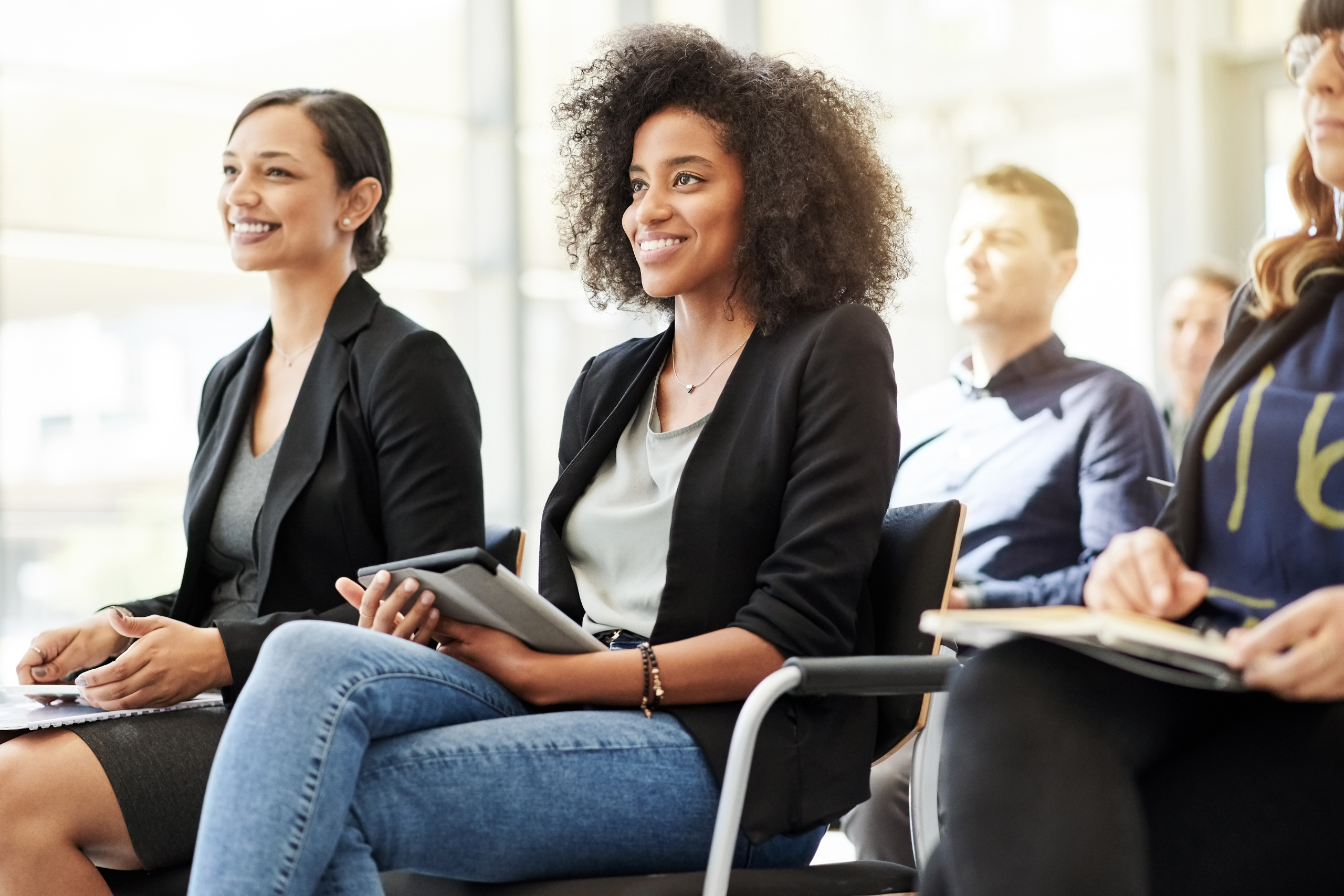 Employees engaged in a wellness education session, showing how health assessments, coaching, and educational tools build awareness and empower informed behavior change.