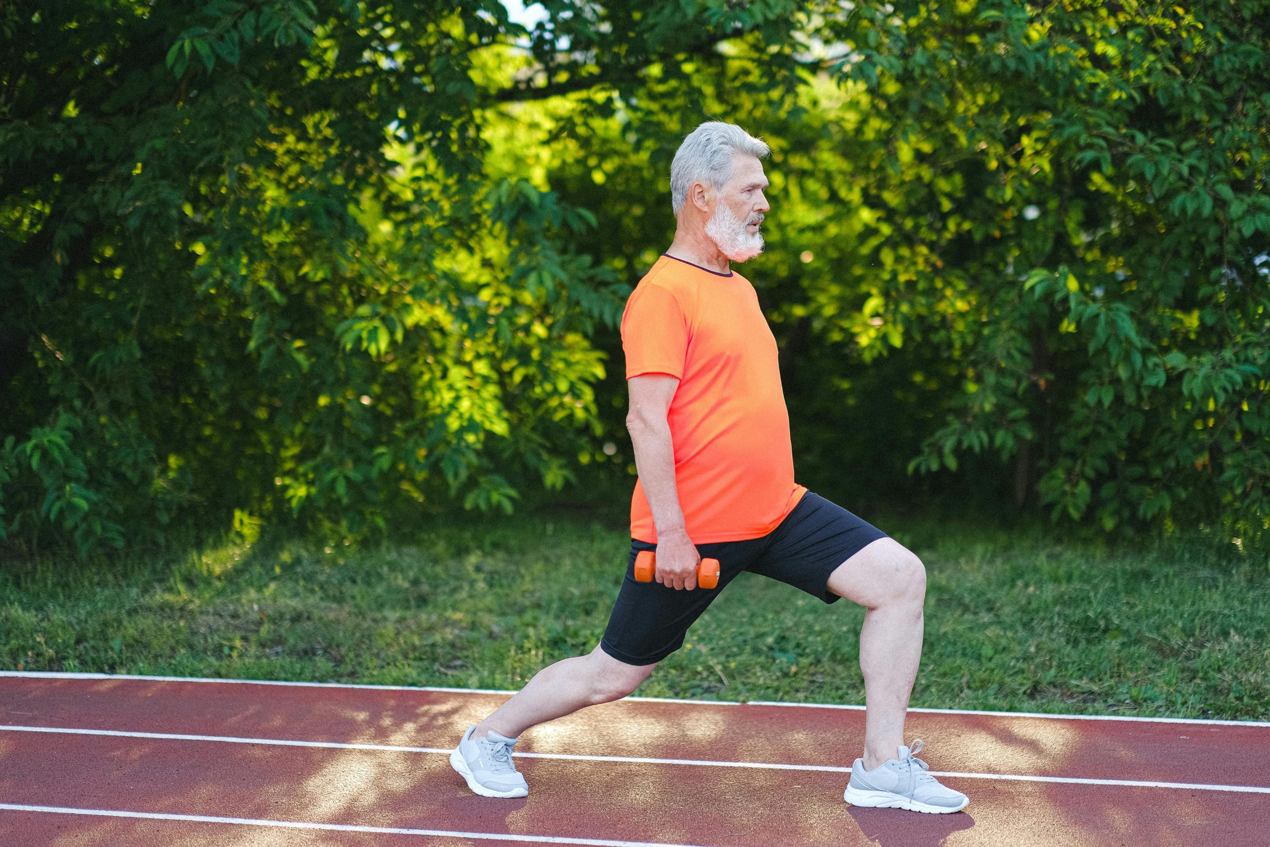 Shows an employee performing a strength exercise outdoors, demonstrating how taking action through wellness challenges and habit builders drives real behavior change in workplace wellness programs.