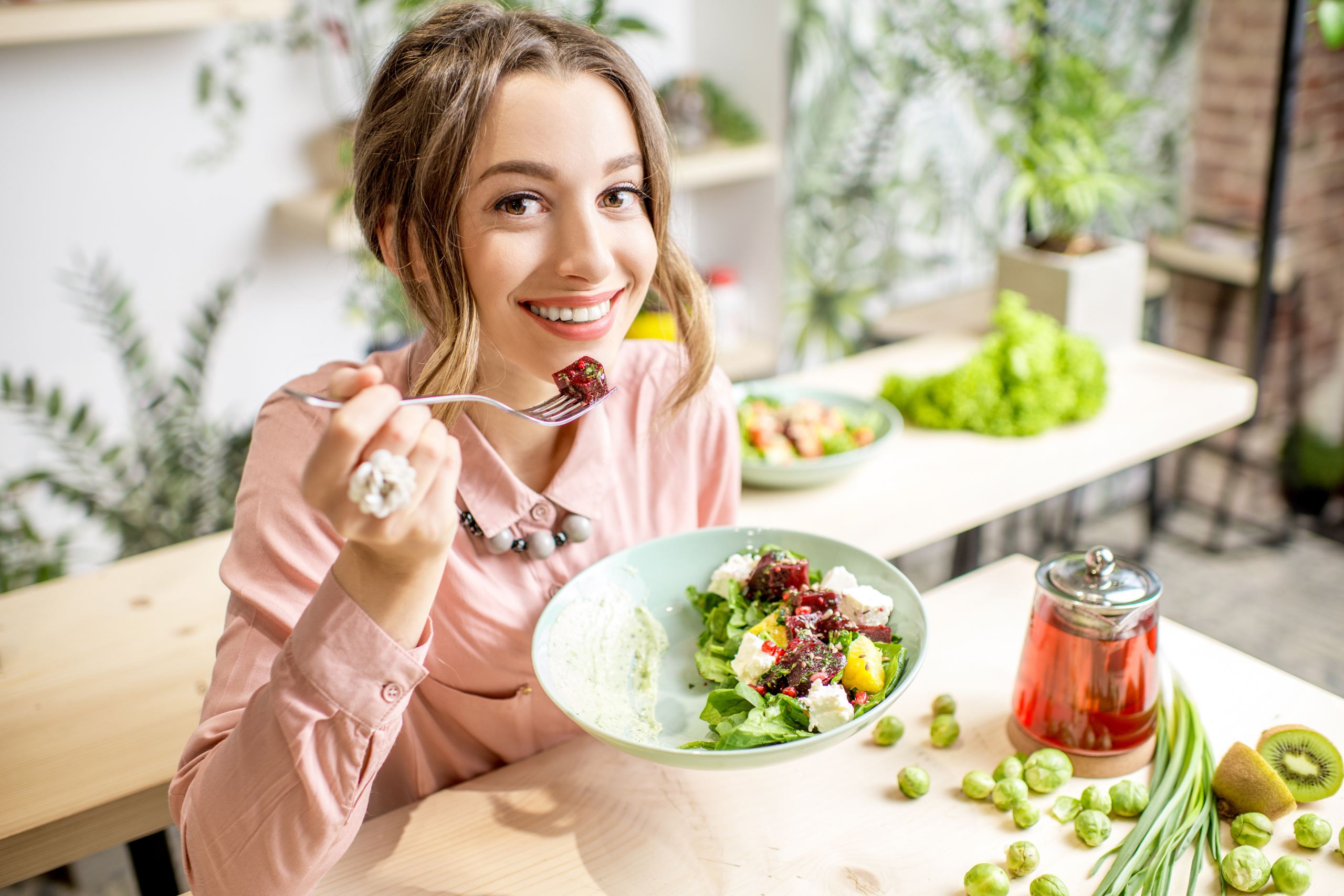 Colorful smoothie bowl with fresh fruits, nuts, and seeds surrounded by healthy snacks, representing balanced nutrition and healthy eating habits in workplace wellness.